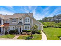 Charming townhome with manicured lawn and inviting entrance, perfect for suburban living at 15 Canary Ct, Durham, NC 27713