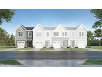Charming townhouse with modern design, a one-car garage, and manicured landscaping at 164 Paramount Dr, Smithfield, NC 27577