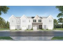 New construction townhome with stylish gray and brown color scheme on a tree lined street at 172 Paramount Dr, Smithfield, NC 27577
