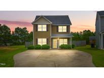 Charming two-story home with a well-manicured lawn and concrete driveway at 19 Kimberly Ct, Lillington, NC 27546