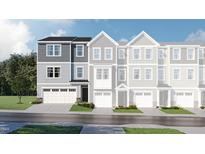 Charming townhome with a two-car garage, manicured lawn, and classic exterior at 221 Carova Bnd, Apex, NC 27539