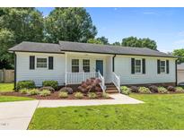 Charming single-story home features white siding, dark shutters, and a well-manicured front yard at 2324 Hoskins Rd, Burlington, NC 27215
