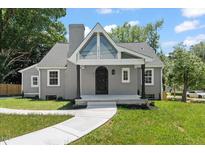 Charming home featuring a well-manicured lawn, freshly painted exterior, and an inviting front porch with an arch door at 2617 Fayetteville St, Durham, NC 27707