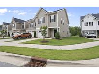 Charming two-story home featuring manicured lawn and neutral siding, complemented by a one car garage at 511 Kenton Mill Ct, Rolesville, NC 27571