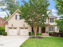 Charming two-story home with a well-manicured lawn and attached two-car garage at 7906 Longleaf Branch Ct, Raleigh, NC 27612