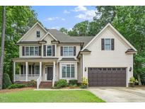 Traditional two-story home with a porch, dormers, and attached garage at 117 Garden Oaks Dr, Smithfield, NC 27577