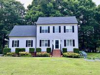 Charming two-story home with lush landscaping and a manicured lawn at 120 Feezor Ct, Clayton, NC 27527