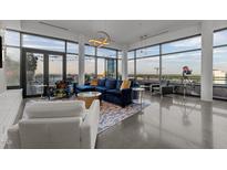 Bright, modern living room features floor-to-ceiling windows, stylish furnishings, and a spacious open layout at 122 N Harrington St # 1555, Raleigh, NC 27603