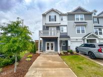 Attractive gray townhome with a two-story elevation and a well-manicured front yard at 124 Sugar Run Dr # 11, Fuquay Varina, NC 27526