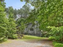View of the exterior of the home surrounded by trees and a driveway at 152 A&B Cedar Terrace, Chapel Hill, NC 27516