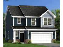 New two-story home featuring dark siding, gray shingles, a front-entry two-car garage and professional landscaping at 233 Steel Spring Rd # 24, Angier, NC 27501