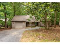 Charming home nestled amongst lush trees and mature landscaping and attached garage at 252 Fox Ridge, Pittsboro, NC 27312