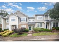 Charming townhome featuring manicured landscaping and inviting green front door under a cloudy blue sky at 3519 Sugar Tree Pl, Durham, NC 27713
