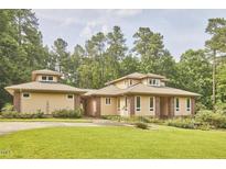 Stunning single-story home with manicured lawn and lovely trees in a private setting at 3605 Laurel Creek Way, Durham, NC 27712