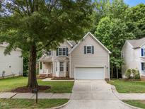 Charming home featuring a well-manicured lawn, two-car garage, and inviting front porch at 412 Hay River St, Garner, NC 27529