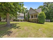 Beautiful home featuring a well-manicured lawn, mature trees, and charming curb appeal at 44 Supreme Dr, Lillington, NC 27546