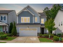 Charming two-story home featuring a two-car garage and well-maintained landscaping at 520 Flip Trl, Cary, NC 27513