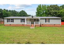 Charming single-story home with a covered porch and a well-maintained lawn at 558 Christys Way, Roxboro, NC 27574