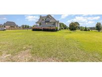 Charming home with lush front lawn and manicured shrubbery, offering a peaceful and inviting curb appeal at 656 Atkins Rd, Fuquay Varina, NC 27526