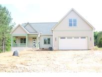 Charming new construction with a two-car garage and front porch, perfect for enjoying the outdoors at 70 Basil Ct, Franklinton, NC 27525