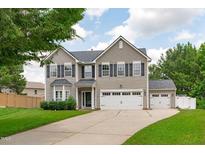 Charming two-story home with attached two car garage and detached garage with manicured lawn at 760 Stackhurst Way, Wake Forest, NC 27587