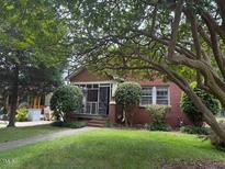 Charming single-story brick home with mature landscaping at 921 Alabama Ave, Durham, NC 27705