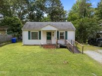 Charming one-story home featuring a well-maintained front yard and handicap ramp access at 101 Goldston Dr, Carrboro, NC 27510