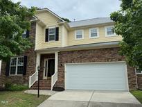 Charming two-story home featuring a stone facade, attached two-car garage, and well-maintained landscaping at 1040 Bellenden Dr, Durham, NC 27713