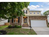 Charming two-story home featuring stone accents, a two-car garage, and a welcoming front entrance with brick steps at 1040 Bellenden Dr, Durham, NC 27713