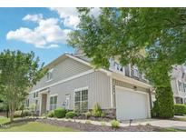 Charming home featuring a two-car garage, stone accents and landscaped yard at 1090 Indigo Ridge Pl, Cary, NC 27519