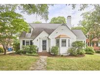 Charming exterior view featuring a well-maintained yard and classic architecture with a chimney at 1104 Englewood Ave, Durham, NC 27701