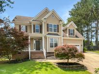 Charming two-story home with a manicured lawn and beautiful curb appeal at 1201 Dagmar Ln, Wake Forest, NC 27587