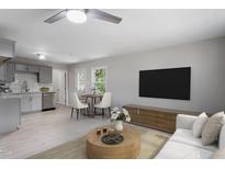 Open-concept living room featuring modern decor, ample seating, and seamless flow into kitchen at 2702 Red Valley Dr, Rougemont, NC 27572