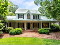 Charming two-story home with a welcoming front porch and lush landscaping at 300 Oak Ridge Dr, Hillsborough, NC 27278