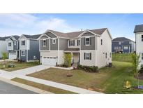 Charming two-story home with neutral siding, gray accents, and a well-manicured lawn at 3421 Lebrun Path, Fuquay Varina, NC 27526
