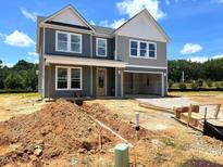 Two-story home featuring gray siding, white trim, covered porch, and an attached garage at 35 Windflower Court Ct # Homesite 9, Clayton, NC 27520