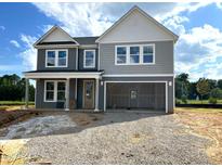 Two-story home with gray siding, white trim, attached two-car garage, and covered porch at 35 Windflower Court Ct # Homesite 9, Clayton, NC 27520