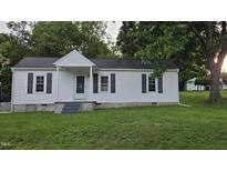 Charming single-story home with white siding, black shutters, and a well-manicured lawn at 426 Smith St, Burlington, NC 27217