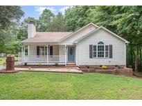Charming single-story home with a inviting front porch and beautifully landscaped front yard at 5428 Passenger Pl, Raleigh, NC 27603