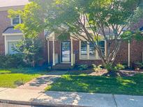 Charming brick townhome with a well-manicured lawn and mature landscaping, exuding curb appeal at 5500 Fortunes Ridge Dr # 94C, Durham, NC 27713