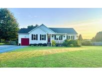 Charming single-story home with a well-maintained lawn and inviting curb appeal at 56 Sugarhill Dr, Zebulon, NC 27597