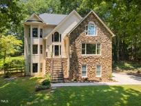Charming home with stone facade, elegant windows, and inviting front steps at 6001 Waters Way Dr, Raleigh, NC 27606