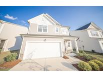 Charming two-story home boasts a spacious two-car garage and manicured landscaping at 1108 Matterhorn Dr, Fuquay Varina, NC 27526
