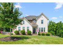 Charming two-story home featuring a well-manicured lawn and appealing architectural details at 1154 Yorkshire Dr, Burlington, NC 27215