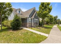 Charming home exterior with stone accents, blue siding, and a well-manicured lawn at 1172 Pemberly Ave, Morrisville, NC 27560