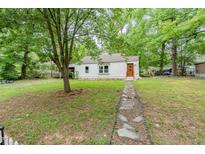 Charming single-story home featuring a stone pathway and lush greenery at 1401 Robinhood Rd, Durham, NC 27701