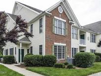 Well-maintained condo with brick accents, green shutters, and landscaped shrubbery at 1911 Kudrow Ln, Morrisville, NC 27560