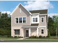 Charming two-story home with a brick and gray siding exterior and a welcoming front porch at 2886 Quarry Rd # 161, Rolesville, NC 27571