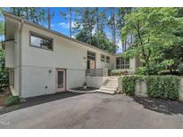 Charming two-story home with brick accents, landscaped entry, and driveway at 3205 Dell Dr, Raleigh, NC 27609