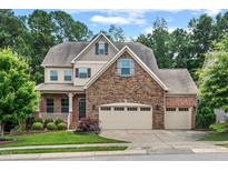 Charming two-story home featuring a stone facade and a well-manicured front yard at 3312 Flat River Dr, Durham, NC 27703
